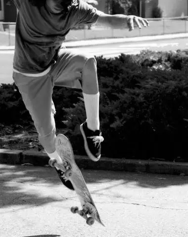 A person on a skateboard doing tricks in the air.