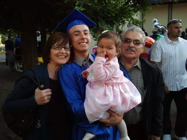 A family posing for a picture with their graduate.