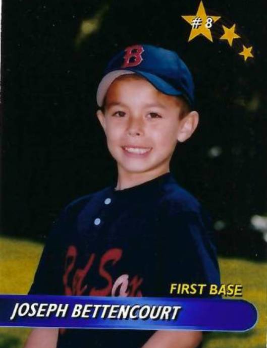 A young baseball player in his uniform.